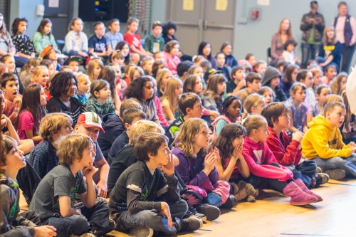 Choir performing in a local school